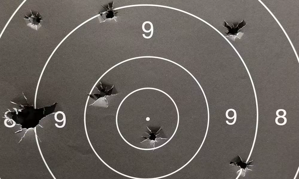 Paper shooting target with bullet holes after a session at the Riga range