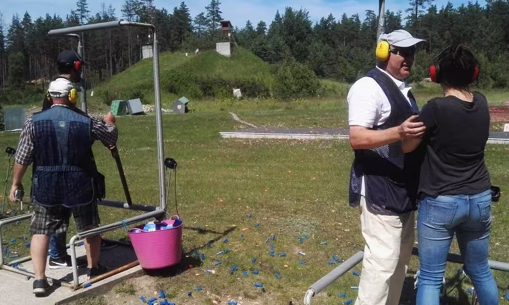 Couple enjoying outdoor clay pigeon shooting near Riga Latvia