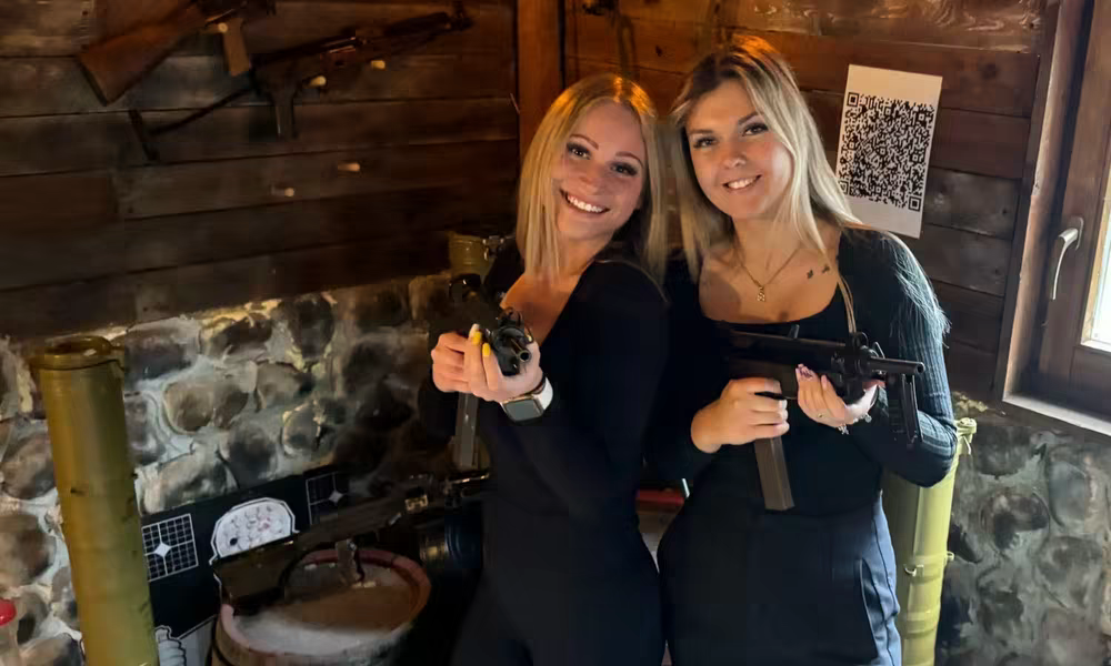 Group of friends posing with firearms after the All In shooting package in Budapest