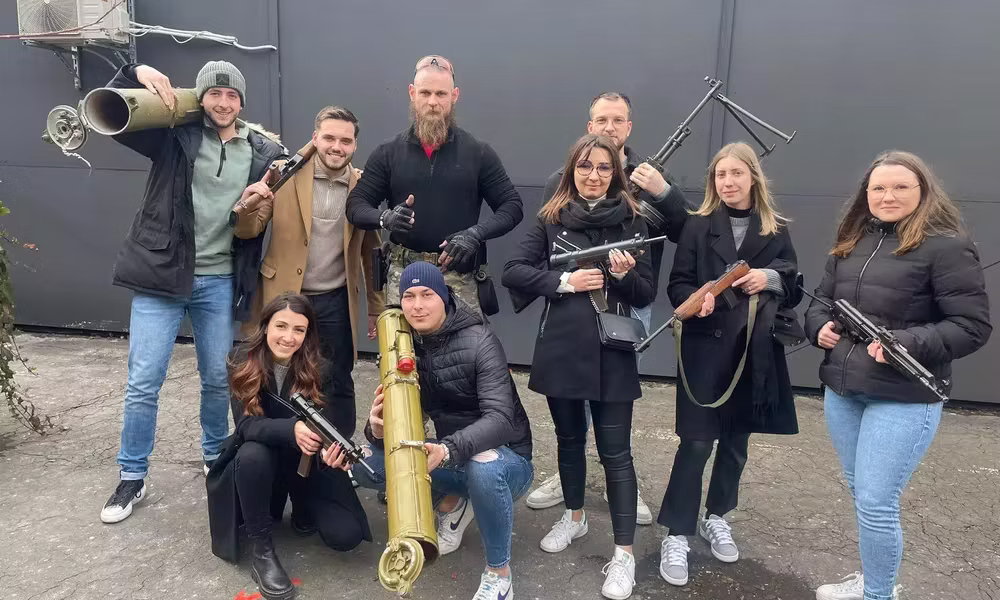 Group posing with firearms at the Budapest indoor shooting range