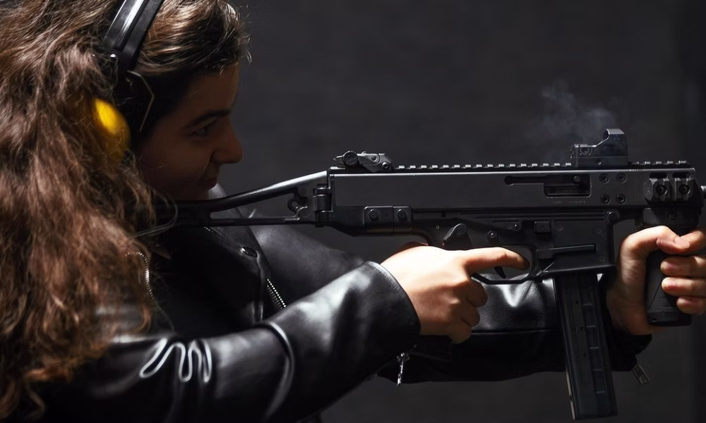 Tourist firing a submachine gun at a private shooting range in Riga, Latvia