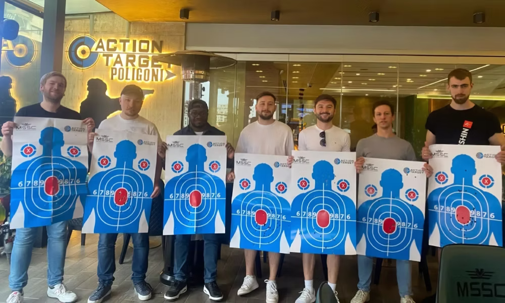 Tourists posing with their targets after completing the Poligon shooting range experience in Tirana, Albania