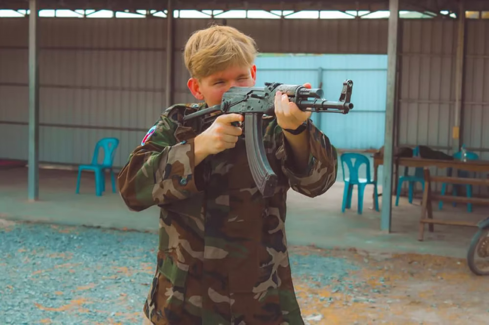 Young man aiming at a target at the outdoor shooting range near Phnom Penh, Cambodia